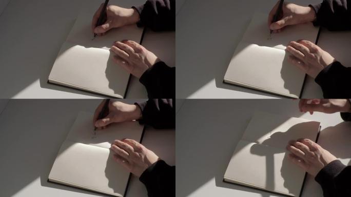 特写: 男性手在日记中写下 “目标” 并在文字下划线