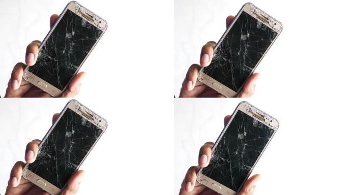 男子手持破碎的智能手机的特写镜头被隔离在白色上