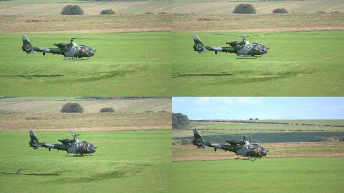 绿色和灰色陆军训练直升机需要悬停并过渡到野外飞行