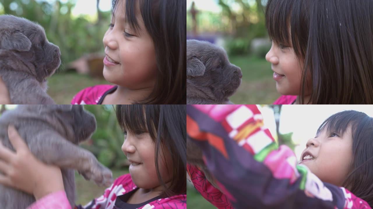 可爱的女孩和她的小狗玩。
