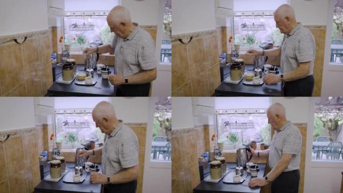 退休期间，早上和茶在厨房柜台上使用水壶，并有空闲时间在家放松。英国老人之家，带茶包或咖啡饮料，以促进