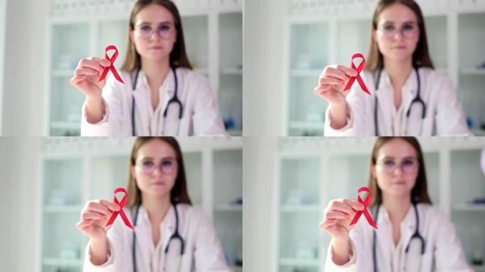 医生展示红丝带治疗和抗击艾滋病和艾滋病毒