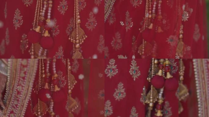 在传统的印度婚礼上，新郎将文化神圣的线绑在新娘的手上。印度婚礼仪式。