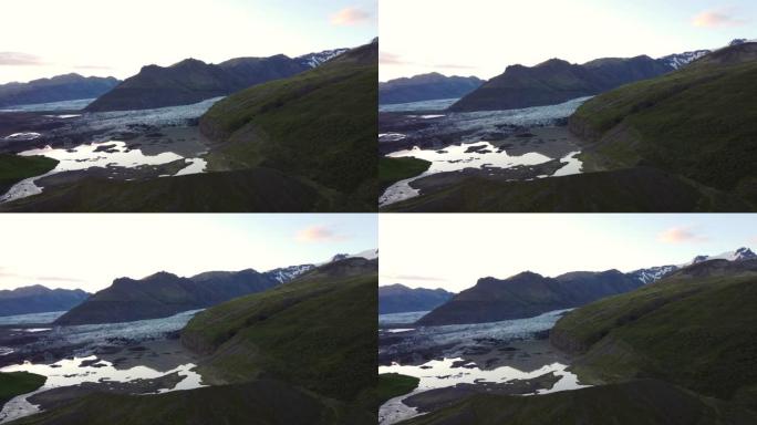 日落冰川在冰岛环城拍摄，无人机向前移动冰川湖中的山的倒影。