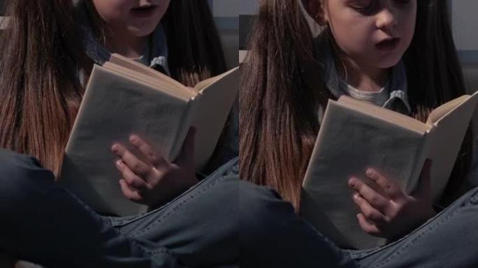 垂直视频孩子阅读爱好智能女孩书