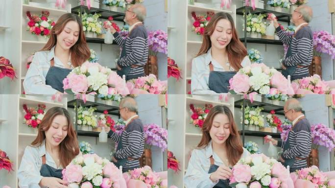 亚洲女花店企业家在花店布置一束鲜花。