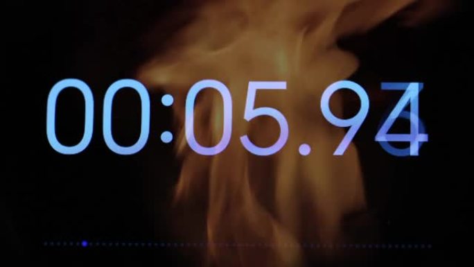 火焰背景特写中的秒表屏幕