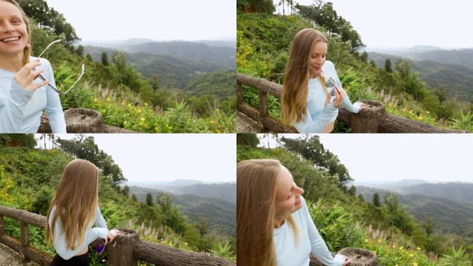 年轻的旅游女子可以从山上高处的木桥欣赏风景，该木桥设计用于从上方观看侧面。在丛林里。山的生动形象。旅