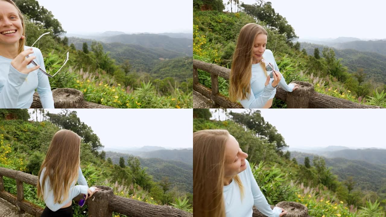 年轻的旅游女子可以从山上高处的木桥欣赏风景，该木桥设计用于从上方观看侧面。在丛林里。山的生动形象。旅