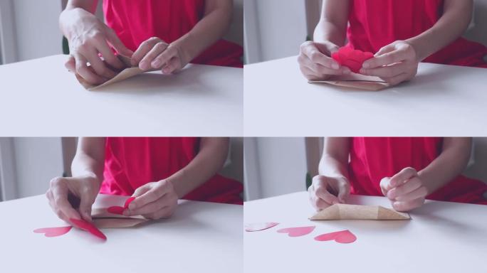一个穿着红色连衣裙的女人在情人节的信封里放了一个红色心形的情人节。爱情宣言，关系概念。