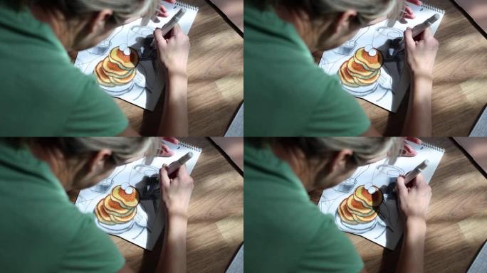 女人在家用铅笔在食物相册中画画