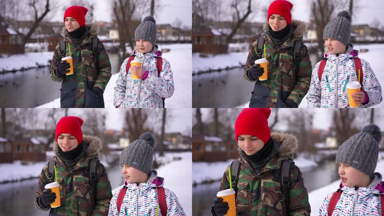 十几岁的男孩和女孩在冬天放学后在户外散步，喝咖啡聊天离开。自信英俊的男生和美丽的女生在户外漫步的肖像