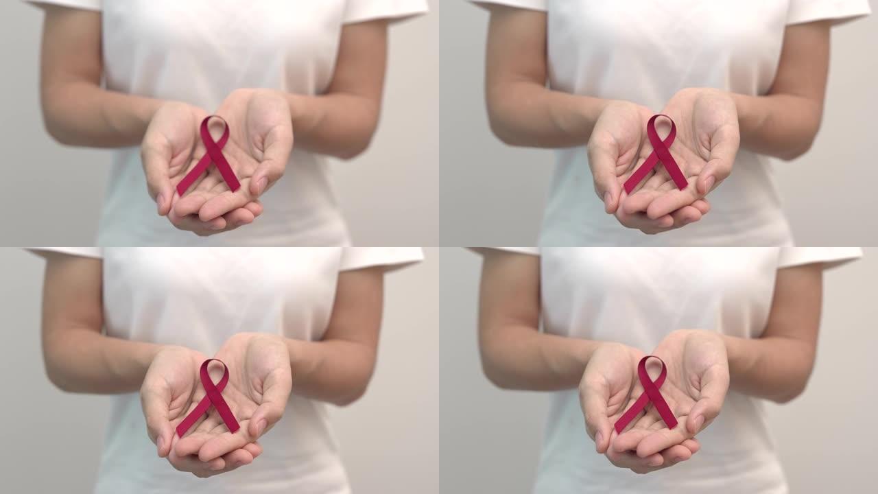 手捧红丝带，12月世界艾滋病日，多发性骨髓瘤癌症宣传月和全国红丝带周。医疗保健和世界癌症日概念