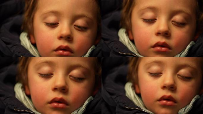 在火车内旅行时睡着的孩子的肖像。沉睡午睡的小男孩特写脸。手持镜头