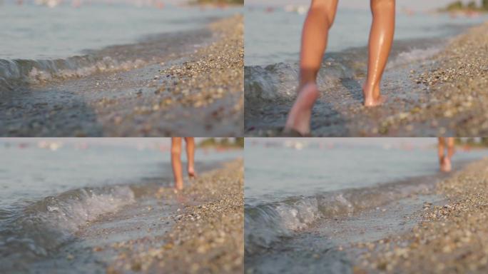 在海滩上跑步的孩子。小石子和沙子上的抽象慢动作男性脚。