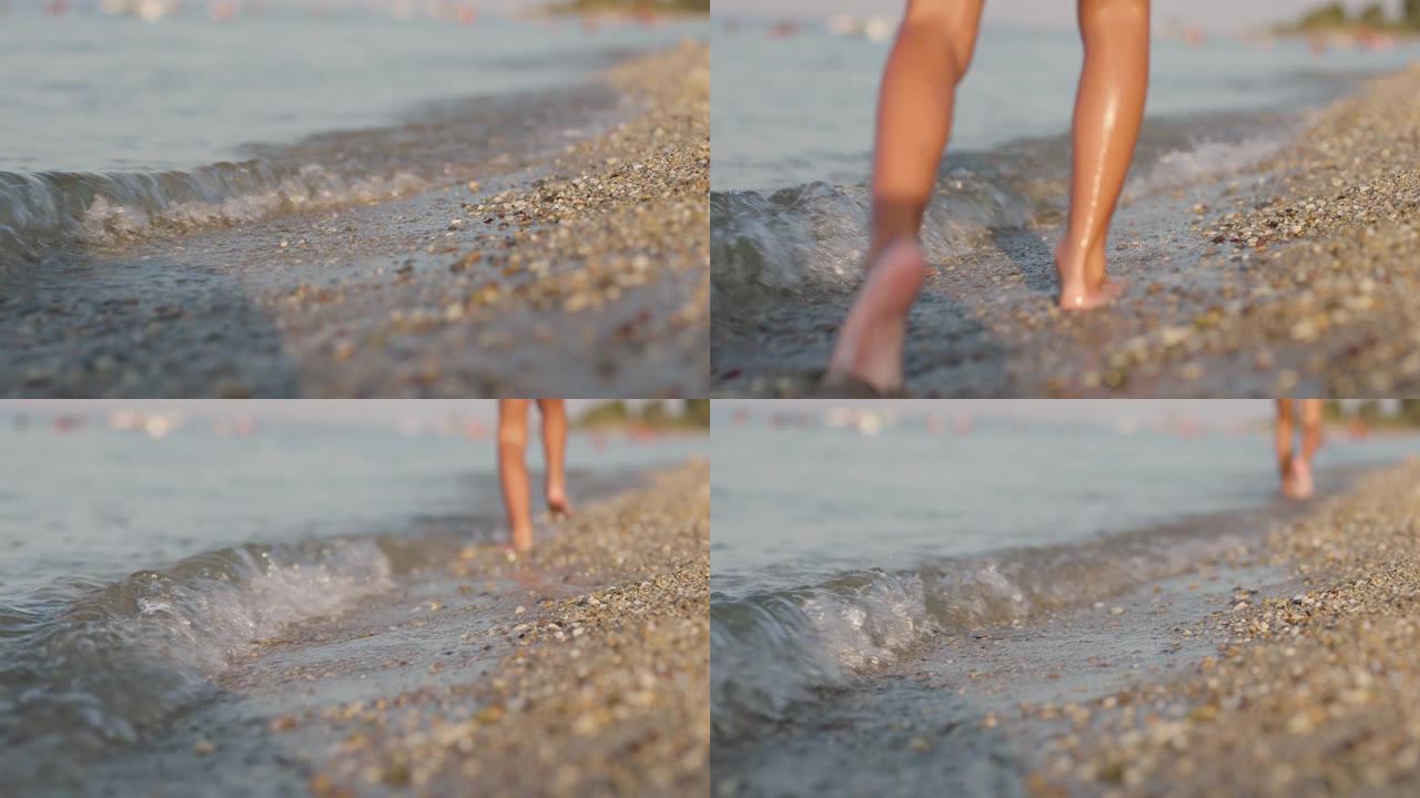 在海滩上跑步的孩子。小石子和沙子上的抽象慢动作男性脚。