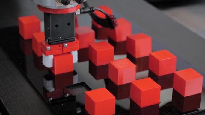 在机器人展览会上挑选并放置机械臂机械手移动红色玩具块