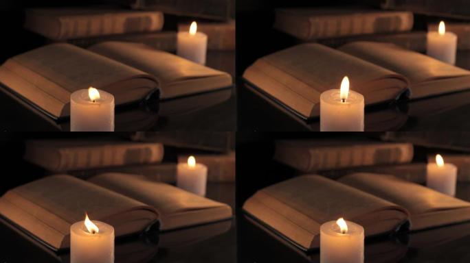燃烧的蜡烛和旧书