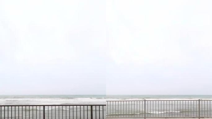 在台风日沿着沿海公路行驶。从汽车上可以看到沿海海洋。