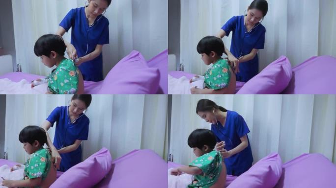 护士正在给发高烧的生病的孩子擦拭自己。