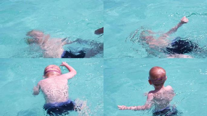 游泳教练教一个孩子游泳。孩子在水中学习潜水白人孩子在夏天戴着泳镜在游泳池里学习游泳。慢动作。