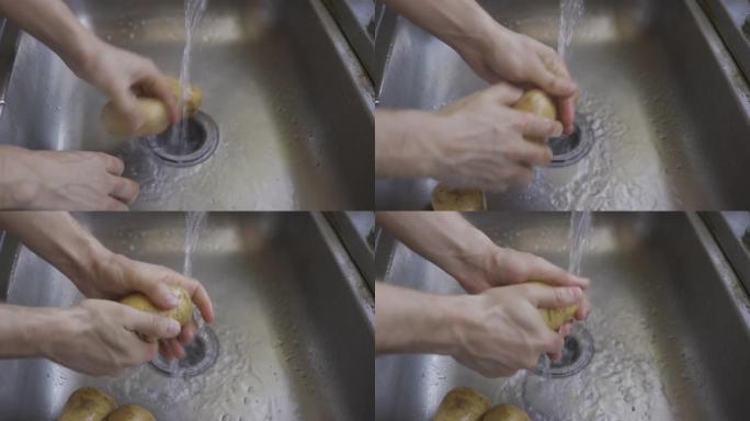 男人的手在水槽里洗土豆。HLG3, BT.2020