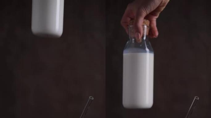 带牛奶的玻璃瓶放在木制厨房桌子上，旁边放着椰子。