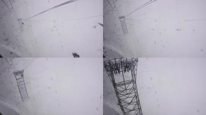 玻璃缆车的鸟瞰图在许多滑雪者92的斜坡上由金属支柱支撑的电缆上下降