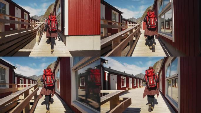 美丽的年轻女孩旅行者去传统红色rorbu前往挪威罗弗登的背景下的木制码头