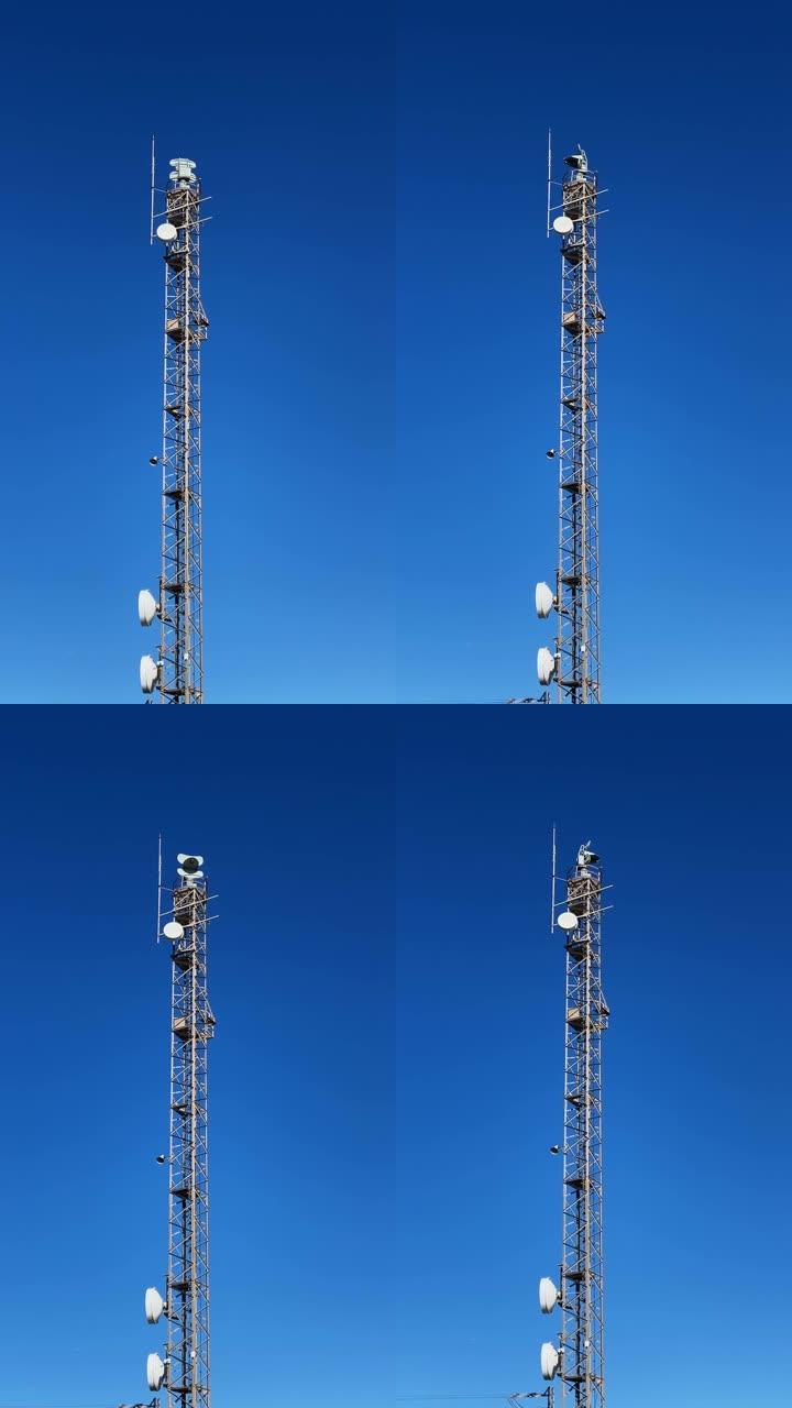 塔雷达站对着晴空，垂直录像。蓝天上的空间雷达天线。雷达控制塔