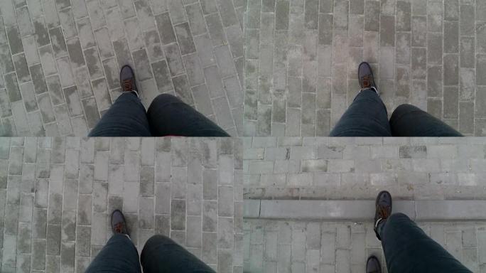 穿着灰色裤子和棕色冬靴的女人腿沿着人行道行走 -- 俯视图。视频9秒