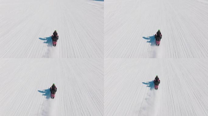 在北极骑雪地摩托的女人的无人机