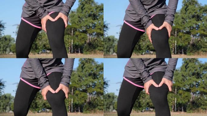 女运动员按摩腿部大腿肌肉疼痛在户外跑步训练。女跑步者触摸腿部肌肉疼痛的特写。肌肉运动损伤。