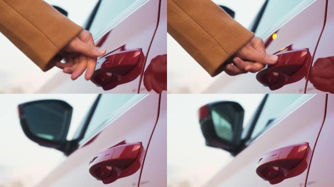 女人的手将手指带到汽车门把手上，将其关闭并折叠后视镜