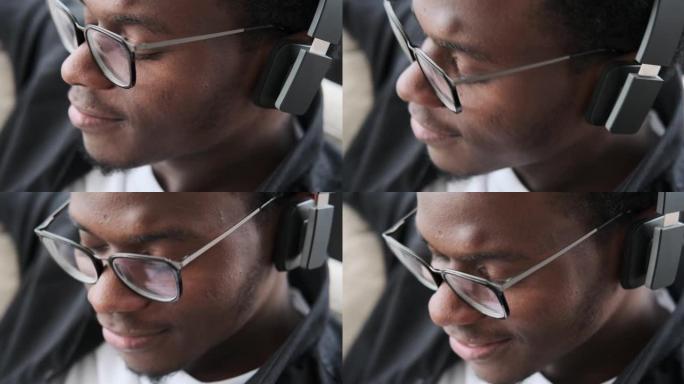 非裔美国人在耳机上听音乐的特写脸