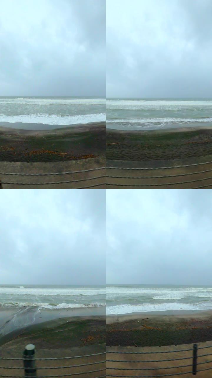 在台风日沿着沿海公路行驶。从汽车上可以看到沿海海洋。