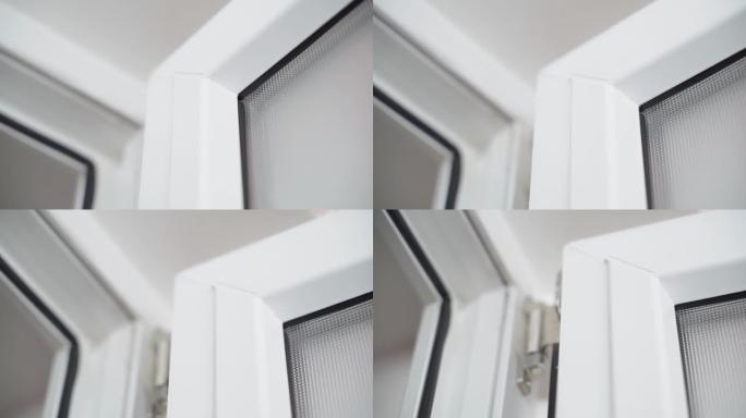 白色塑料门，带不透明玻璃特写。平稳的摄像机运动