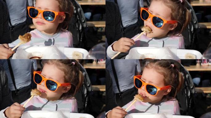 儿童小女孩派对眼镜肖像用筷子吃酱油肉饺子