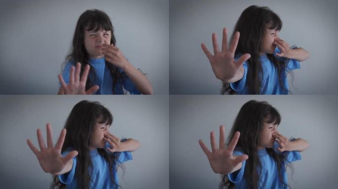 孩子用手指在鼻子上屏住呼吸。