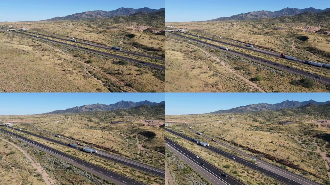 鸟瞰图、半决赛和汽车在沙漠中的高速公路上行驶，背景是山脉
