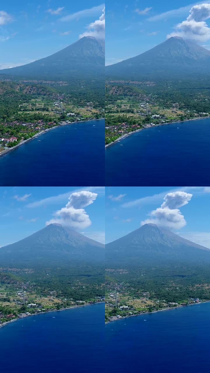 岛屿海岸的垂直视频，背景为黑沙滩和火山爆发