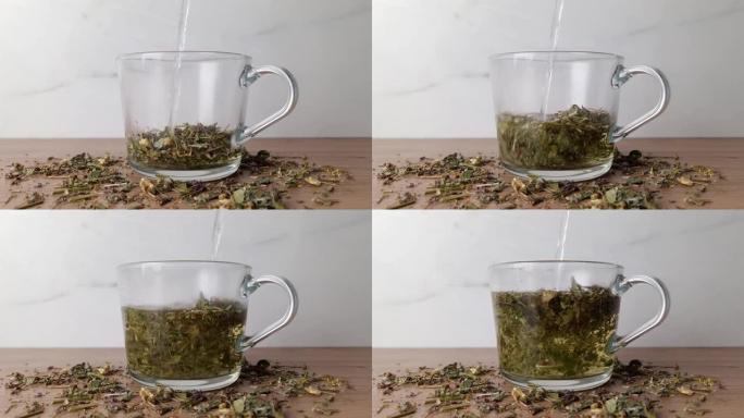 热水落入装满各种草药的玻璃杯中。冲泡凉茶工艺