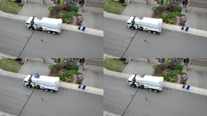 无人驾驶飞机拍摄的回收卡车拉起并装载回收物以进行进一步处理。
