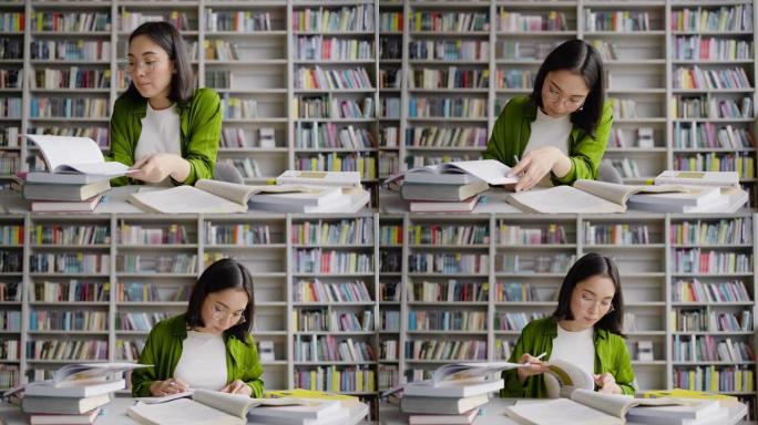 亚洲女学生在图书馆的笔记本上进行总结