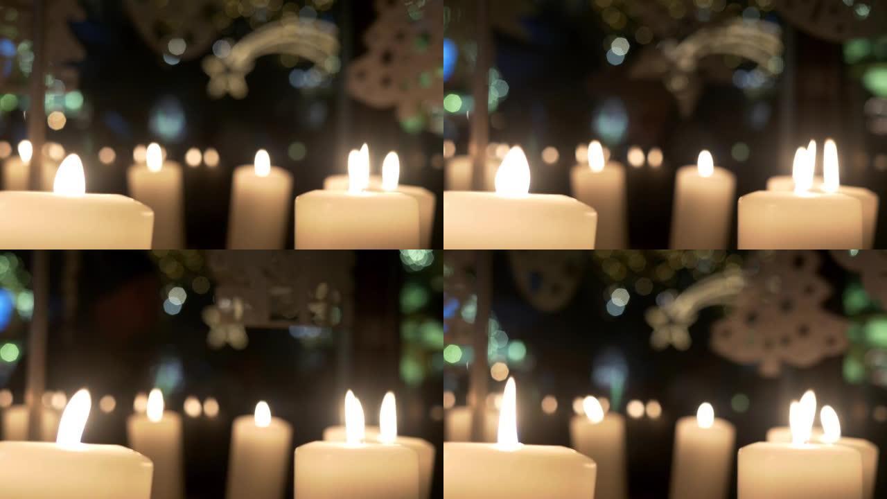 降临节白色蜡烛上的旋转装饰由胶合板制成，描绘天使或圣诞树15