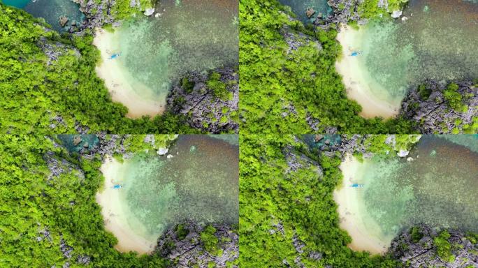 环礁和绿松石泻湖上的热带岛屿。岩石岛，白色沙滩，鸟瞰图。