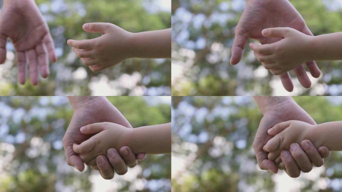 4k视频慢动作妈妈和女儿手牵手，绿色公园背景。