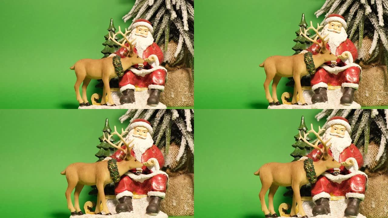 绿色背景上圣诞老人形状的石膏新年玩具。