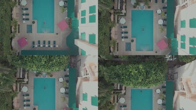 一名女子在高清泳池游泳的空中镜头