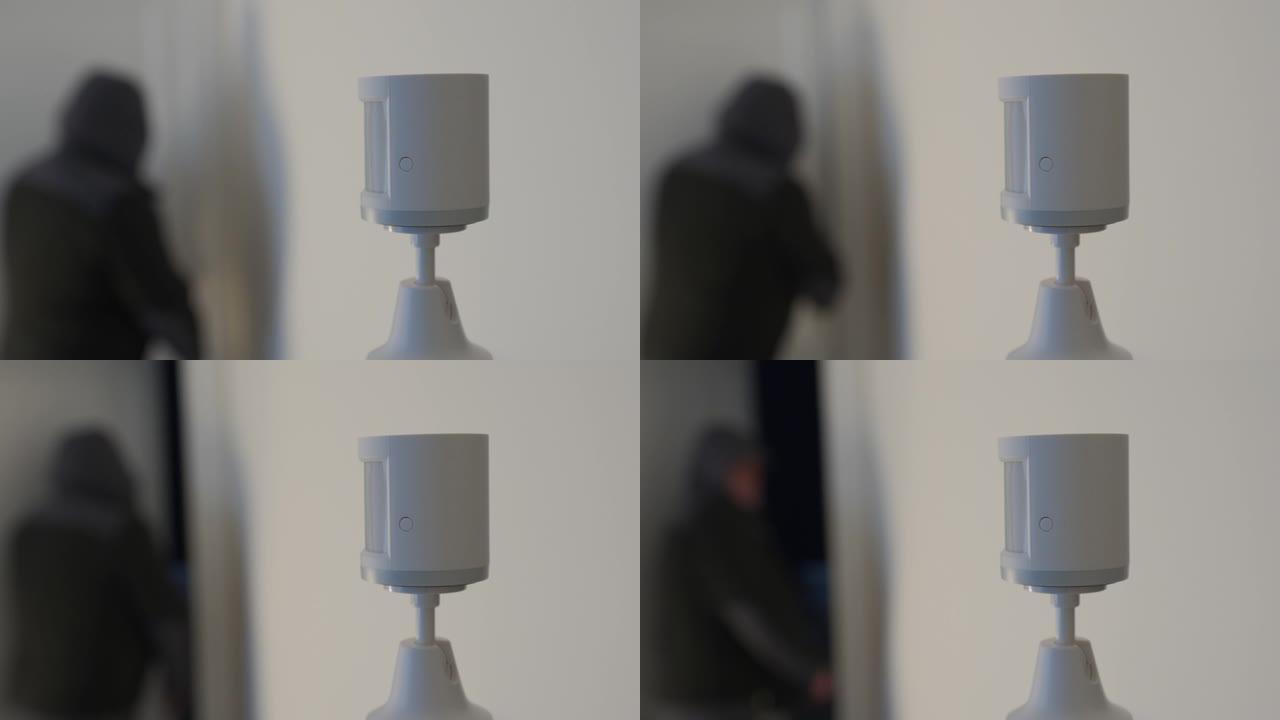安防报警运动传感器安装在房屋墙壁上，无线运动检测器检测入室盗窃发送报警信号。智能家居设备。